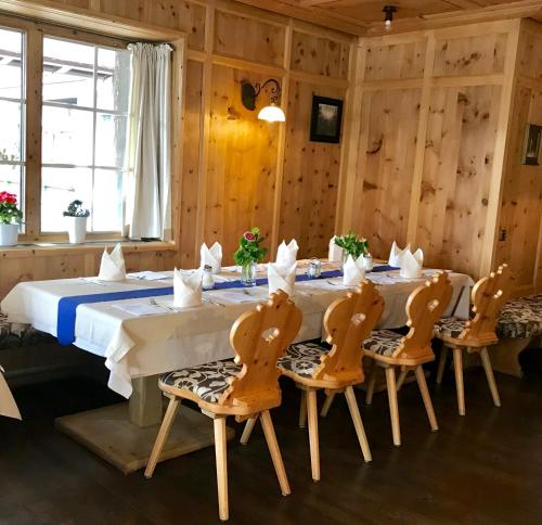 a wooden dining room with a table and chairs at Hotel Tipotsch in Stumm
