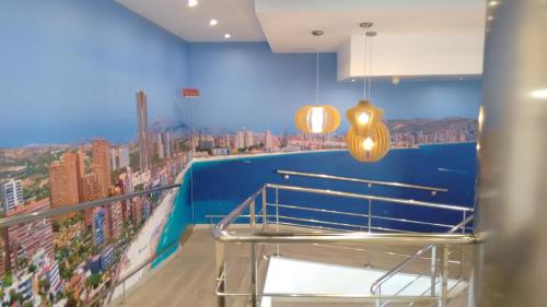 a room with a balcony with a view of a city at Hotel Montemar in Benidorm