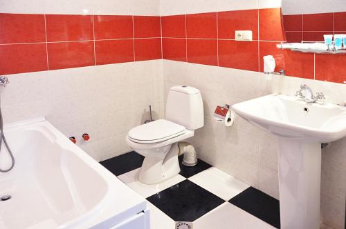 a bathroom with a white toilet and a sink at Hotel Corner in Tbilisi City