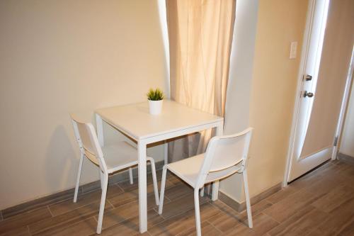 a white table and chairs with a plant on it at California Comfort & Suites in Los Algodones