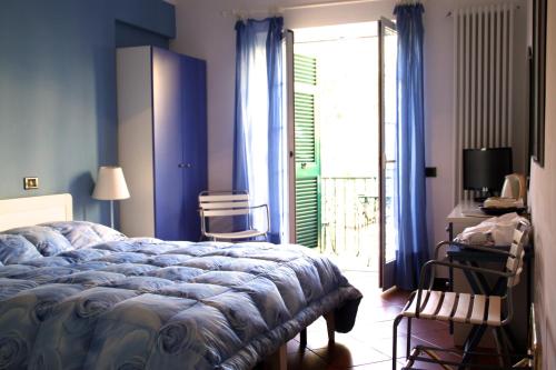 a blue bedroom with a bed and a sliding glass door at Villa Clelia in Levanto