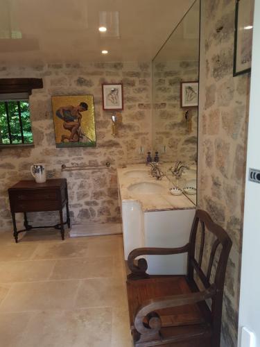 a bathroom with a sink and a mirror at Moulin du soustre in Cavagnac