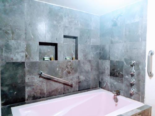 ein Badezimmer mit einer Badewanne und einem Waschbecken in der Unterkunft Hotel Del Parque in Tequisquiapan