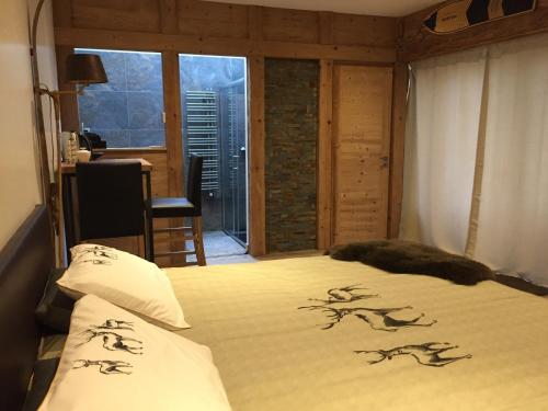 a bedroom with a bed with animal drawings on it at Aux Pays Des Sucs in Saint-Hostien
