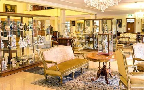 a room with chairs and a table and glass cases at The Residence at Barossa Chateau in Lyndoch