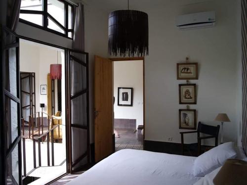 a bedroom with a bed and a large glass door at Dar d'Art in Marrakech