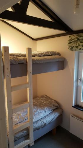 a bedroom with two bunk beds in a room at Cozy home in between Malmö & Lund in Åkarp