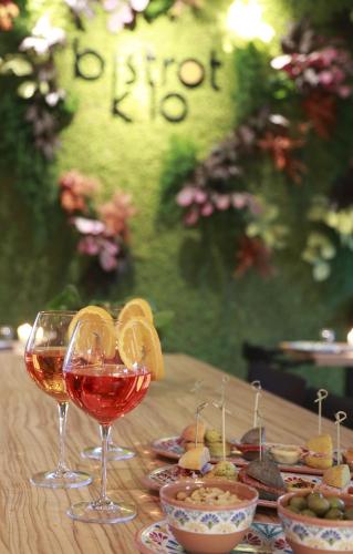 a table with glasses of wine and bowls of food at Hotel Aloisi in Lecce