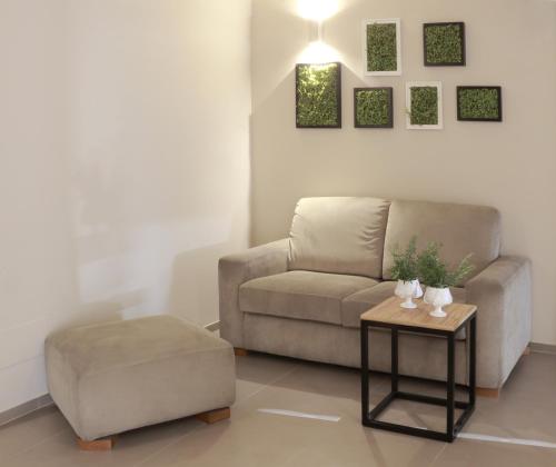 a living room with a couch and a table at Hotel Aloisi in Lecce