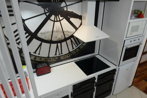 a kitchen with a clock on the wall at Apartman Rustik in Belgrade