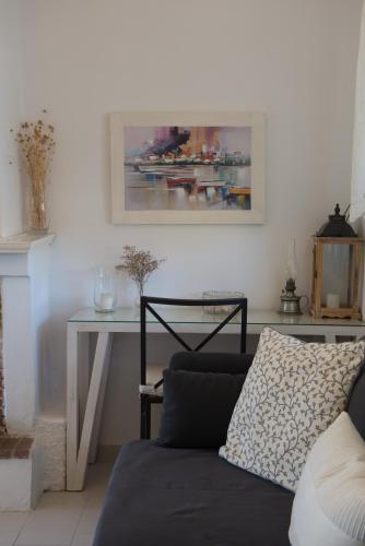 a living room with a couch and a table at Maistros Holiday Home in Vourvourou