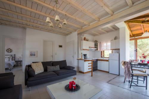 a living room with a couch and a table at Maistros Holiday Home in Vourvourou