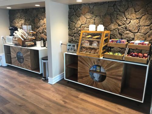 a bakery with two shelves with bread and other items at The ISO by Castle in Kapaa