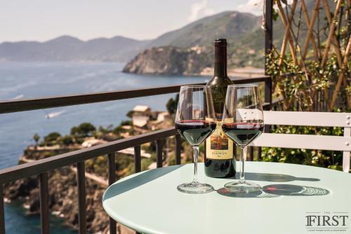 a wine glass sitting on top of a wooden table at Il Sogno di Manarola by The First in Manarola