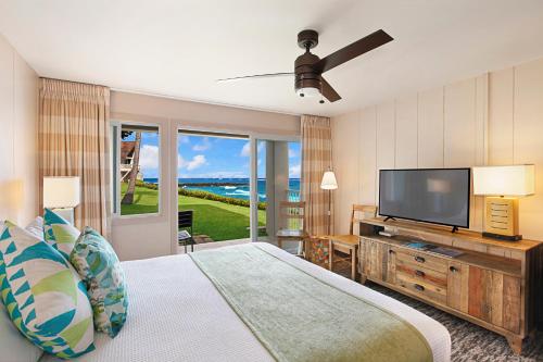 a bedroom with a bed and a flat screen tv at The ISO by Castle in Kapaa