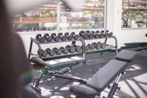 a gym with a bench in front of a window at Tikal Futura Hotel & Convention Center in Guatemala