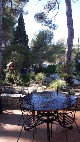 a patio table with a blue table top at villa le grilladou in Hyères