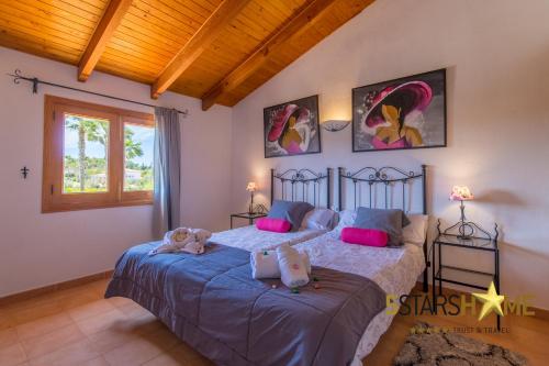 a bedroom with two beds with stuffed animals on them at Can Picafort - 232562 in Santa Margalida