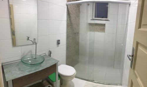 a bathroom with a shower with a toilet and a sink at Casarão Hotel in Santos