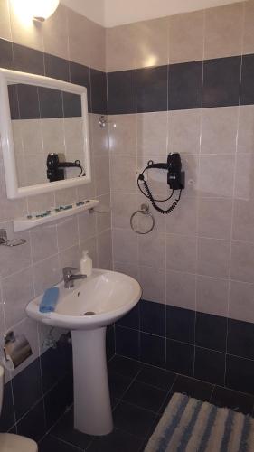 a bathroom with a sink and a mirror at Maria Studios in Paleokastritsa