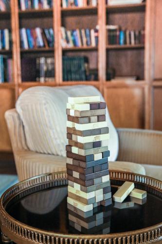 a stack of books on a coffee table in a library at The Rigdon House in Cambria