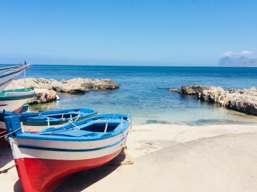 two boats sitting on the sand on a beach at Villa MiraMar Exclusive Home Palermo Airport in Carini