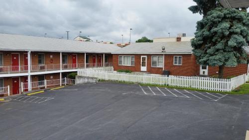 a parking lot in front of a red brick building at The Boston Inn in Westminster