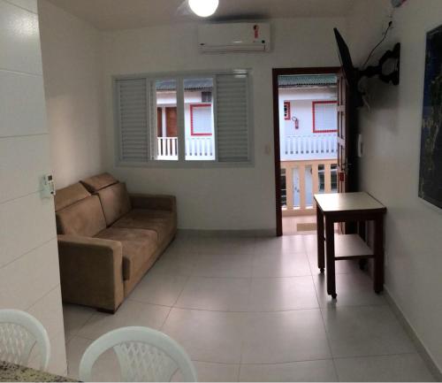 a living room with a couch and a table at Pousada e Camping Lagoa da Conceição in Florianópolis