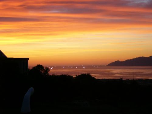 a sunset over a body of water with the sky at Iwanai Kogen Hotel in Iwanai