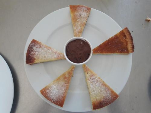 a white plate with four pieces of food on it at Agriturismo Tenuta La Siesta in Gallipoli