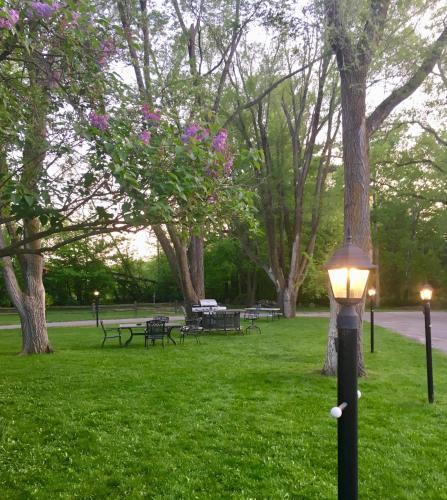 a street light in a park with benches and trees at Elk Rapids Lakeshore Inn in Elk Rapids