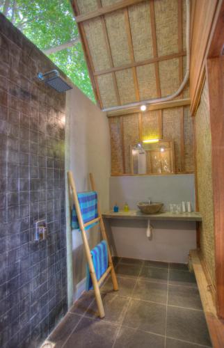 a bathroom with a shower and a sink at Villa Hoomea Private Pool - Adults Only in Gili Islands