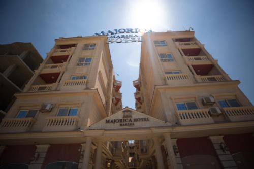 a tall building with a sign on it at Majorica Marina Hotel in El Alamein
