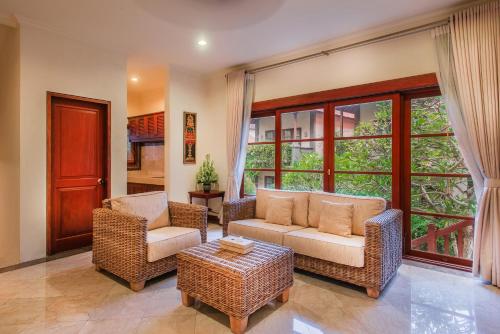 a living room with two chairs and a couch at Samhita Garden Ubud in Ubud