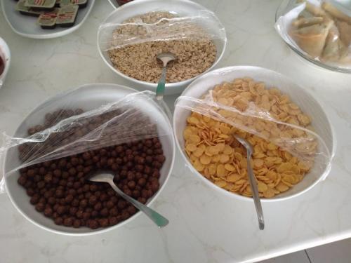 quattro ciotole di noci e arachidi in sacchetti di plastica su un bancone di Damlatas Elegant Apart Hotel a Alanya