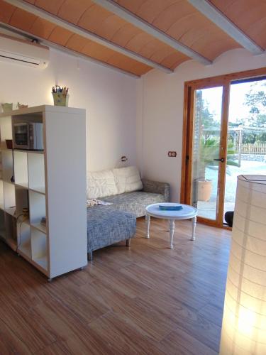 a living room with a couch and a table at can jaume portas in Sant Francesc Xavier
