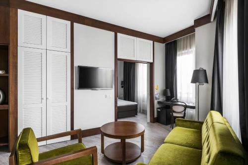 a living room with a couch and a table at Comfort Hotel LT - Rock 'n' Roll Vilnius in Vilnius