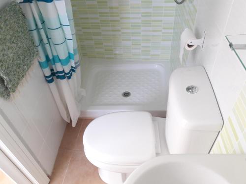 a bathroom with a white toilet and a shower at CH II Apartments ZONA DE OCIO NOCTURNO in Conil de la Frontera
