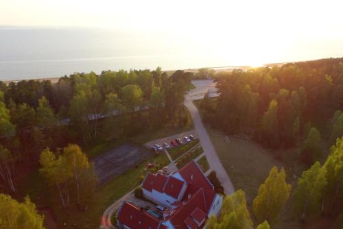 an aerial view of a house with trees and a road at Guest House Karle in Vitrupe