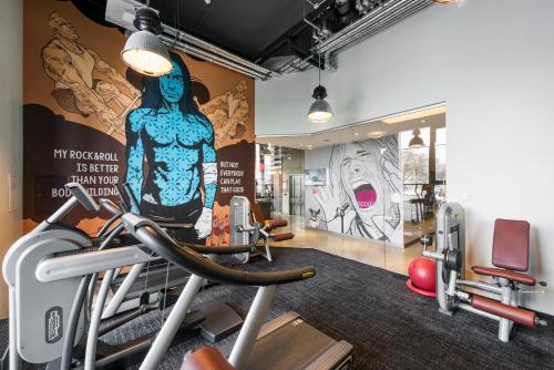 a gym with a large mural on the wall at Comfort Hotel LT - Rock 'n' Roll Vilnius in Vilnius