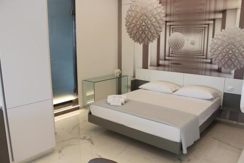 a bedroom with a bed with two pillows at Kalì B&B in Bari