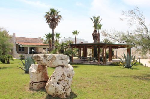 a rock sculpture in a park with a gazebo at Kalì B&B in Bari