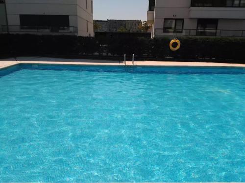 a large blue swimming pool with a frisbee in it at Ático de Lujo en el Centro de Burgos in Burgos