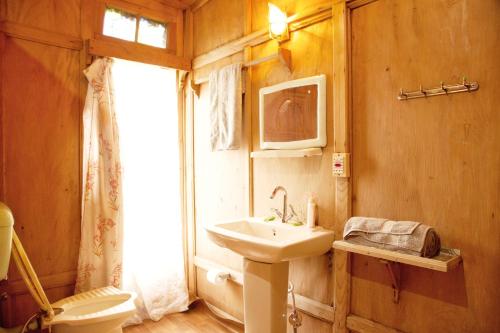 a bathroom with a sink and a toilet at New Bul Bul Group of Houseboats Srinagar in Srinagar