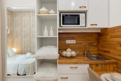 a small kitchen with a sink and a microwave at Budapest Holidays Residence in Budapest