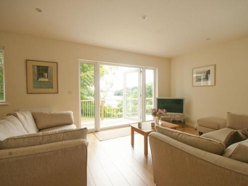 a living room with two couches and a television at The Meadow in Feock