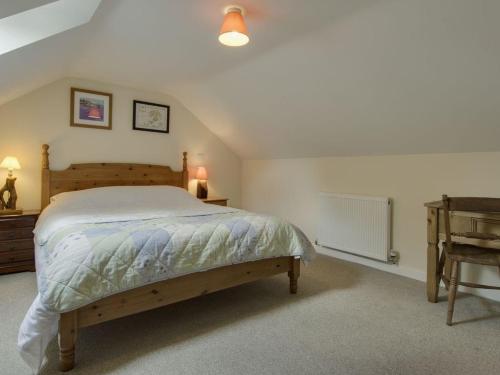 a bedroom with a large bed and a desk at The Old Engine House in Bodmin