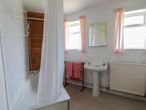 a bathroom with a sink and a mirror at 1 Westcroft Cottage in Stonehouse