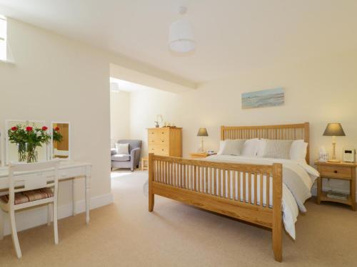 a bedroom with a bed and a desk at Carpenters Cottage in Cockermouth