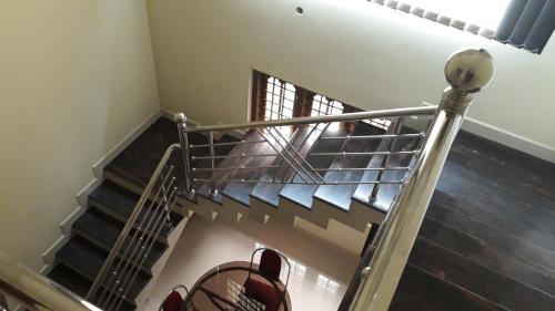 a spiral staircase in a house with shoes on it at White Petals -3 BHK Homestay Munnar - Available For Indian Nationals Only in Munnar